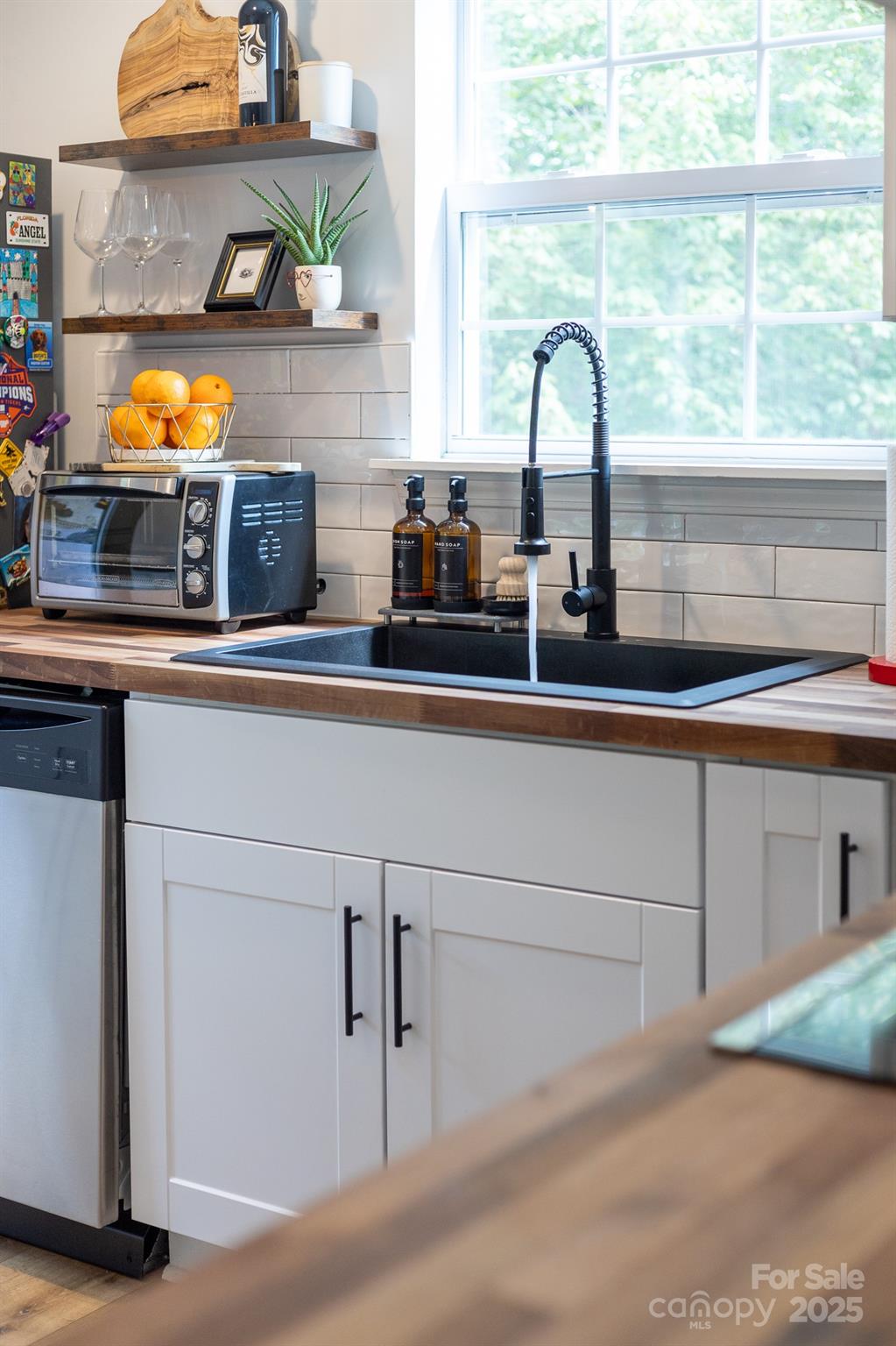 1542 Maypine Commons Way Rock Hill, SC 29732 - Photo 9 of 36 a kitchen with a sink and a stove next to a window