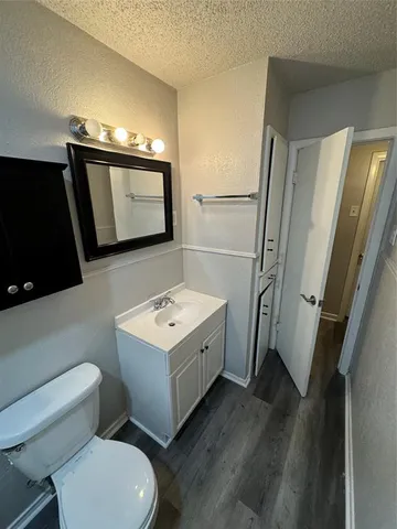 a bathroom with a toilet a sink a mirror and a bathtub