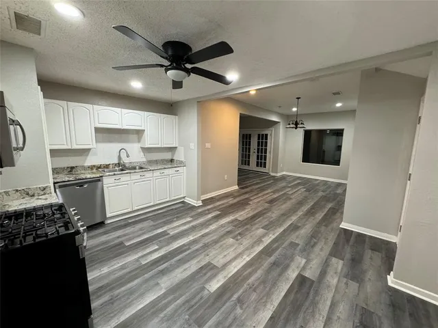 a kitchen with a refrigerator and a stove top oven