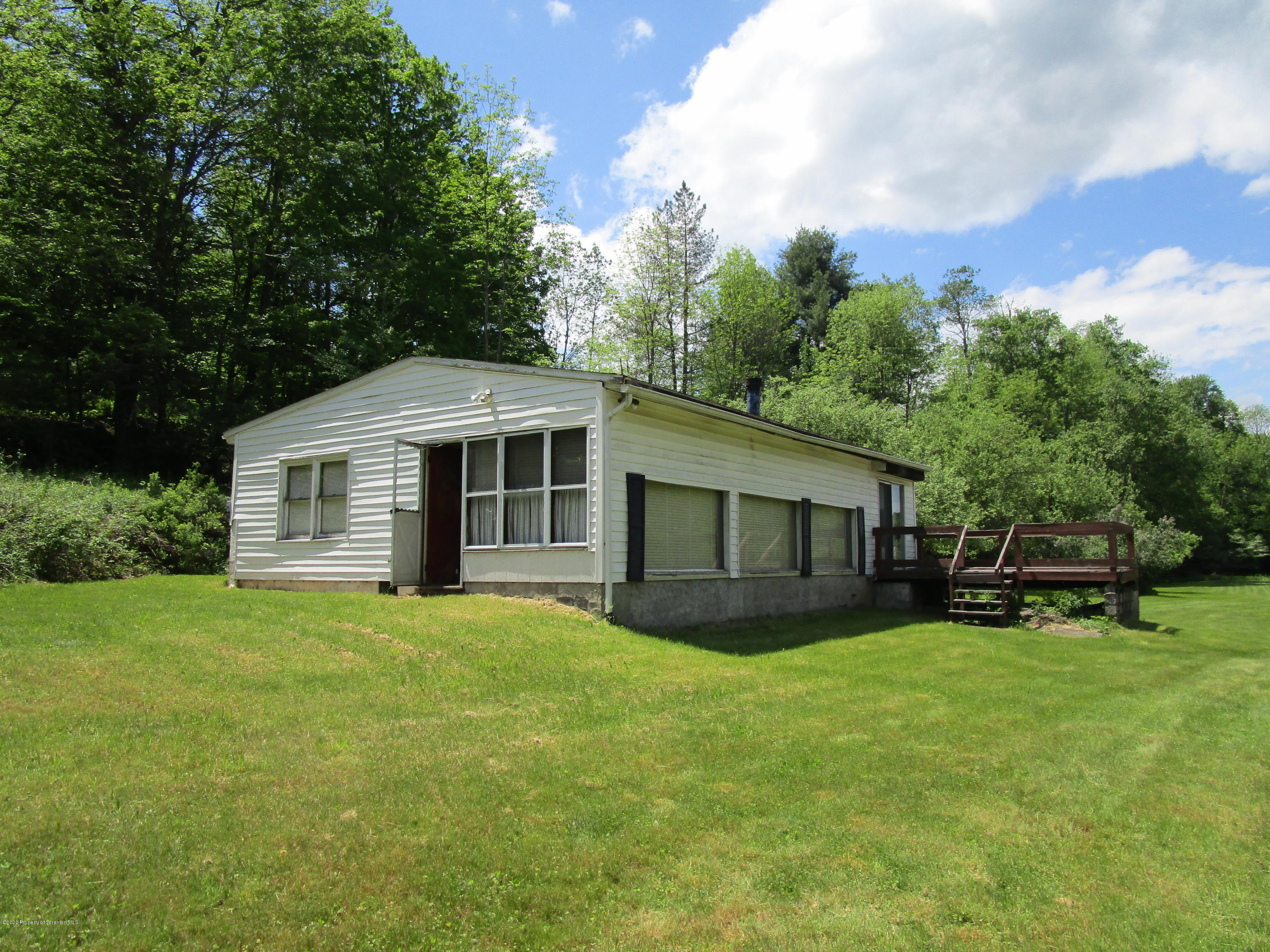 1815 Melrose Road Susquehanna, PA 18847 - Photo 2 of 11 a front view of house with yard and trees in the background