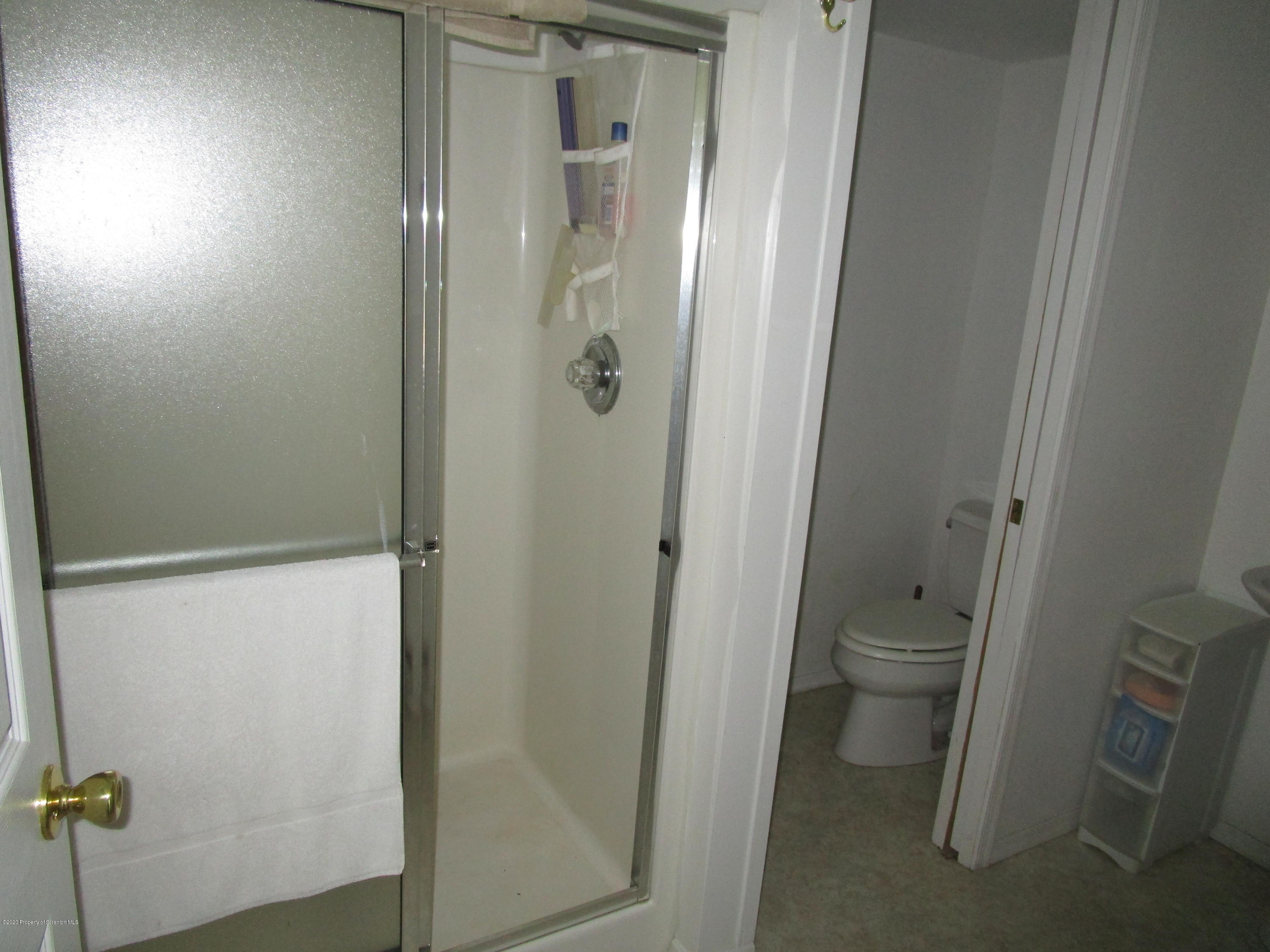 1815 Melrose Road Susquehanna, PA 18847 - Photo 4 of 11 a bathroom with a granite countertop sink toilet and shower