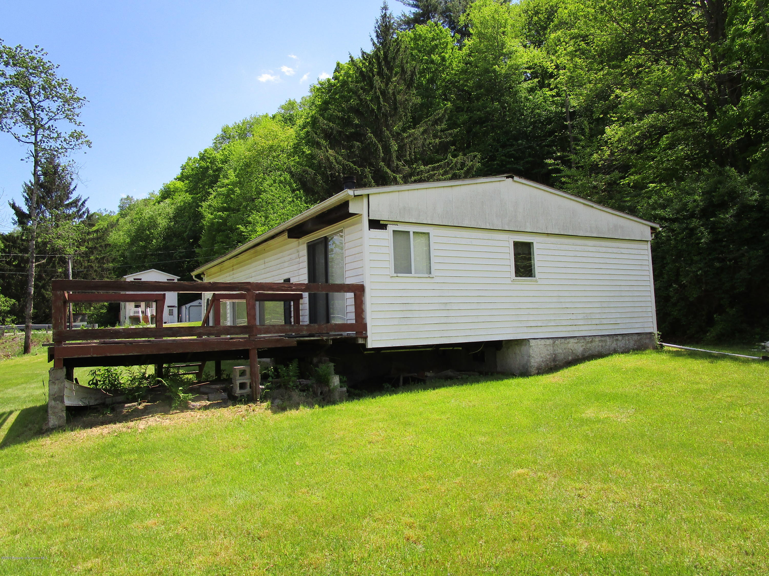 1815 Melrose Road Susquehanna, PA 18847 - Photo 9 of 11 a house that has a big yard with wooden fence