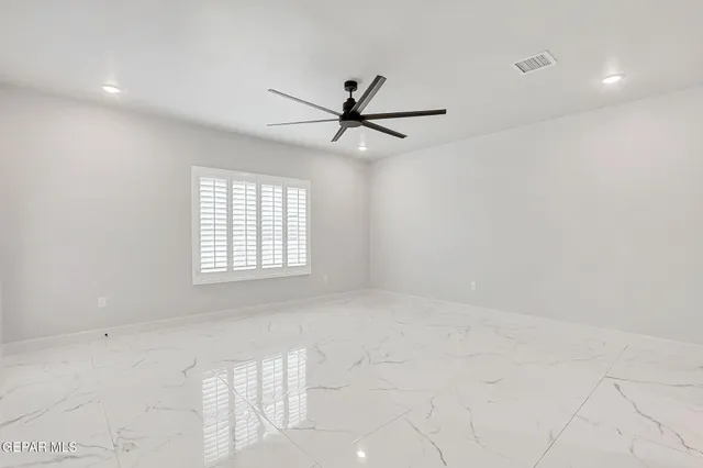 a view of a livingroom with a ceiling fan and window