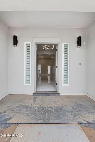a view of an empty room with a fireplace and a window
