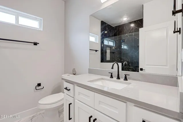 a bathroom with a glass shower door