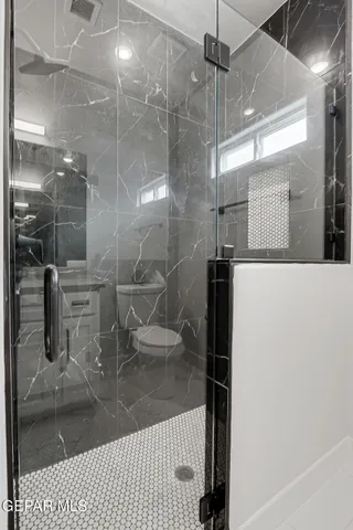 an empty room with ceiling fan and window