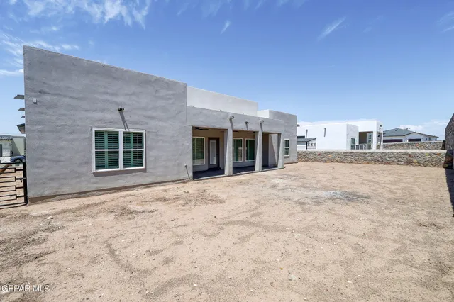 a view of empty field with wooden fence