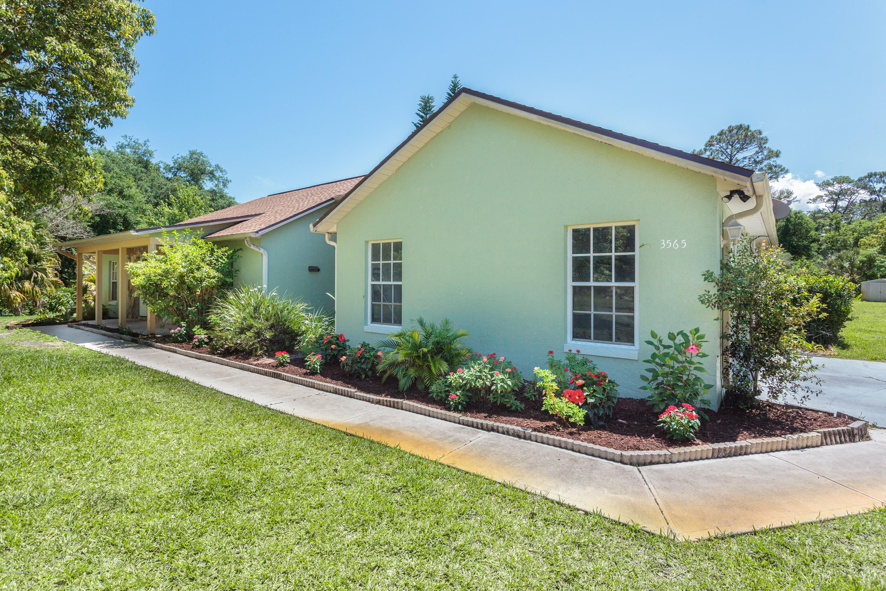 3565 John's Road Mims, FL 32754 - Photo 2 of 21 Flowered lined walkway