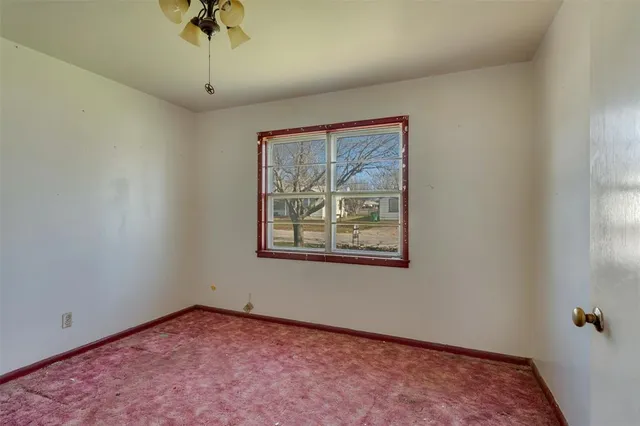 a view of a ceiling fan and window