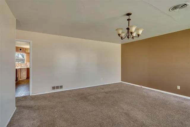 a kitchen with granite countertop a sink a counter space and cabinets