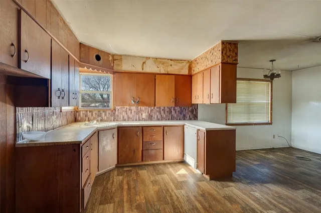 a kitchen with stainless steel appliances granite countertop a sink and cabinets
