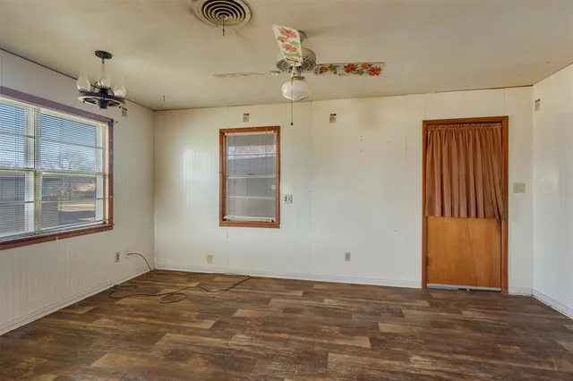 a large kitchen with stainless steel appliances kitchen island a large counter top and wooden floors