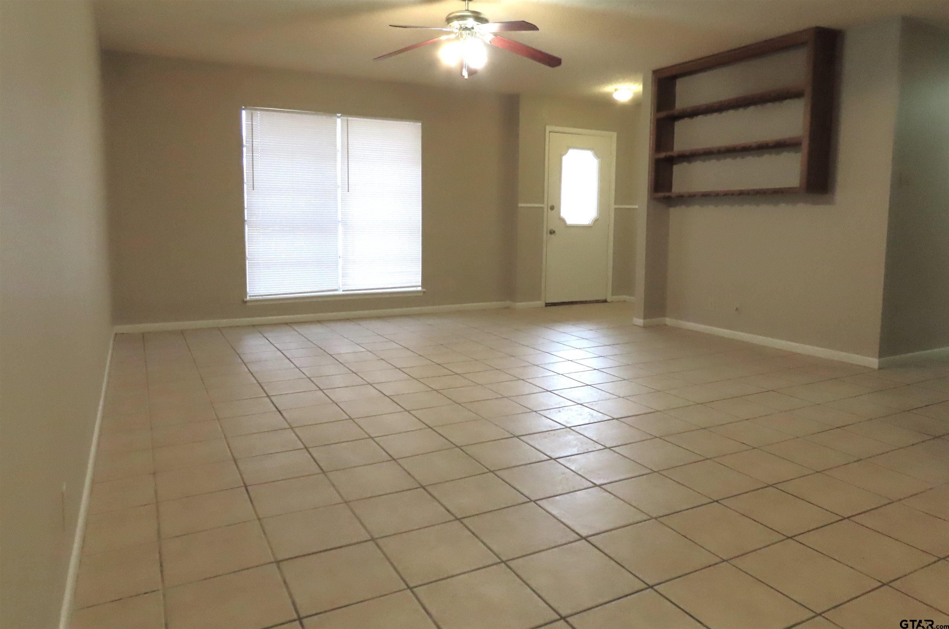 402 Muller Garden Road Tyler, TX 75703 - Photo 4 of 33 an empty room with windows and painted walls