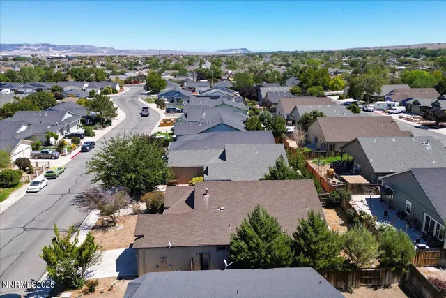 an aerial view of residential houses with outdoor space