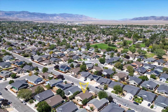 an aerial view of residential houses with outdoor space
