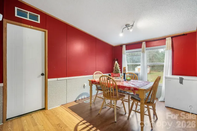 a dining room with furniture and wooden floor