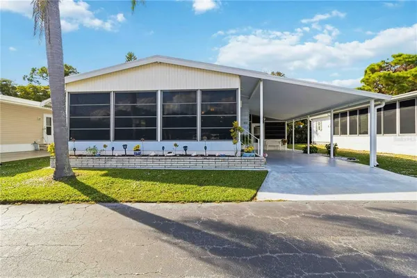 a view of a house with a swimming pool and sitting area