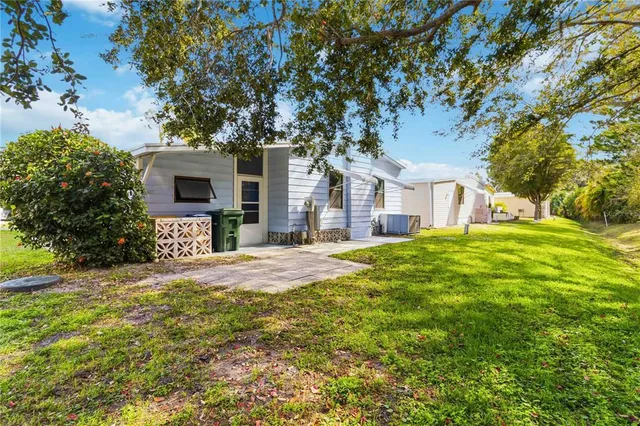 a backyard of a house with table and chairs