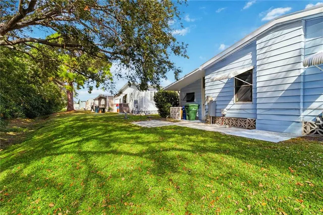 a view of a house with yard and sitting area