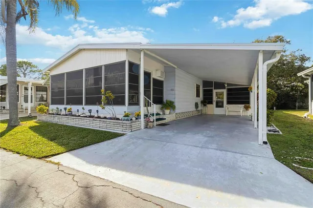 a front view of a house with a garden and patio
