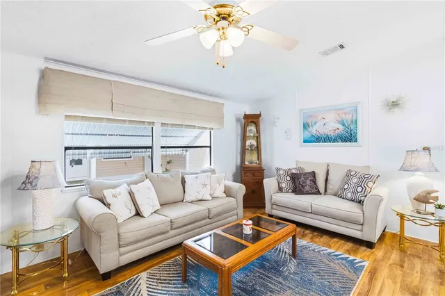 a living room with furniture a chandelier and a rug