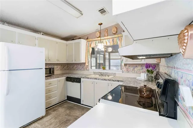 a kitchen with a sink a stove and refrigerator