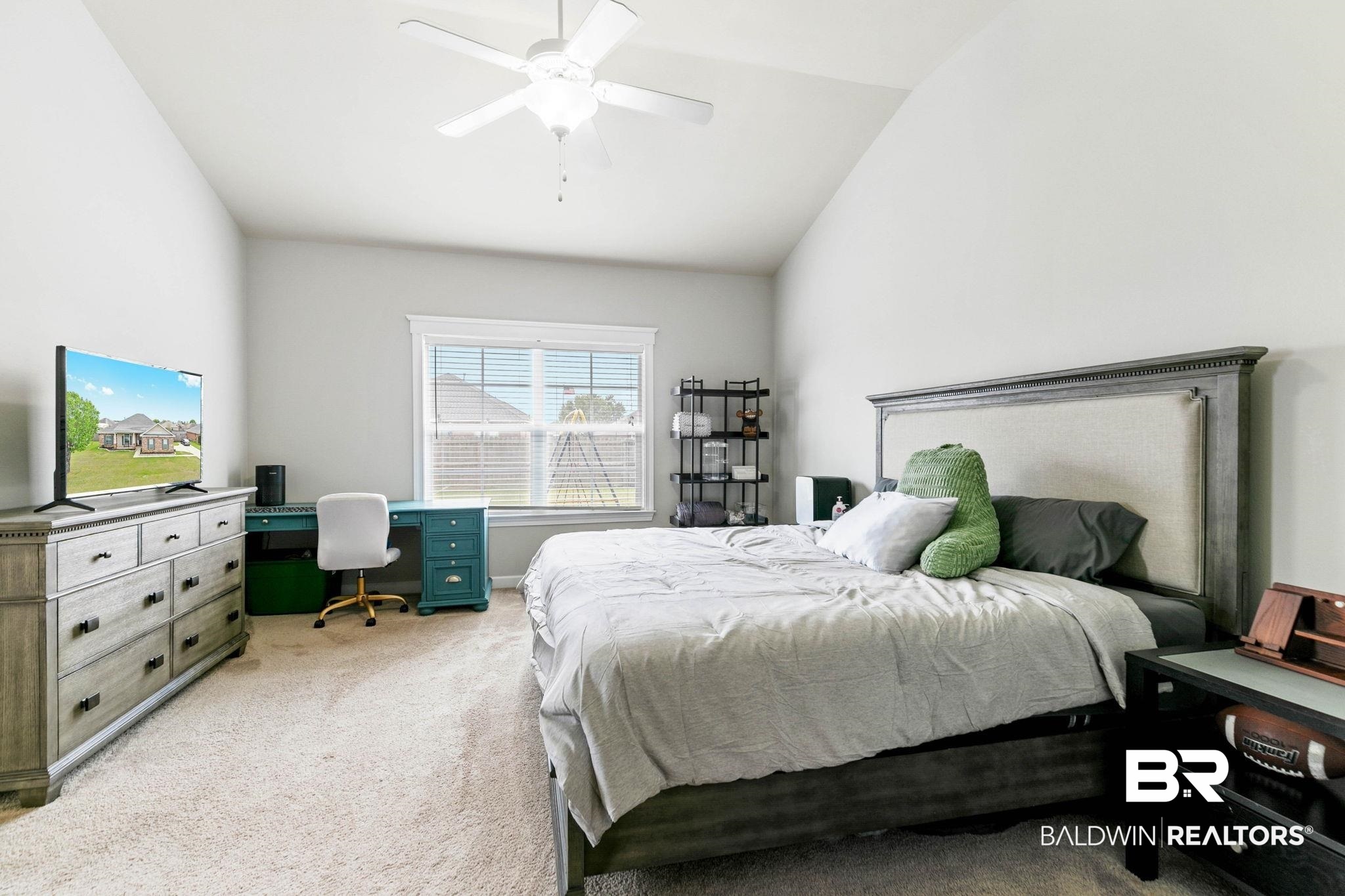 9177 Labrador Trail Theodore, AL 36582 - Photo 16 of 24 Bedroom with lofted ceiling, light colored carpet, a desk, and a ceiling fan