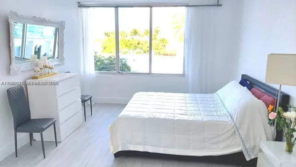 a bed room with a bed and a window