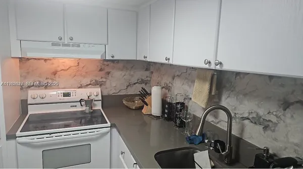 a bathroom with a shower and a sink