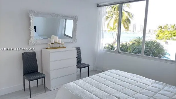 a bedroom with pink walls and pink rug