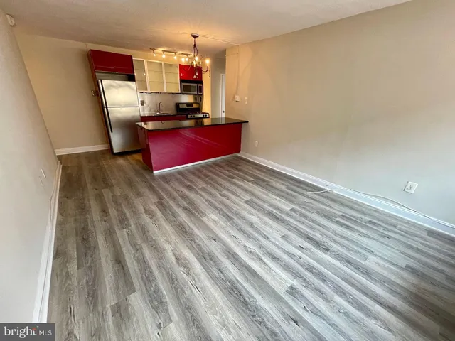 a room with wooden floor and furniture