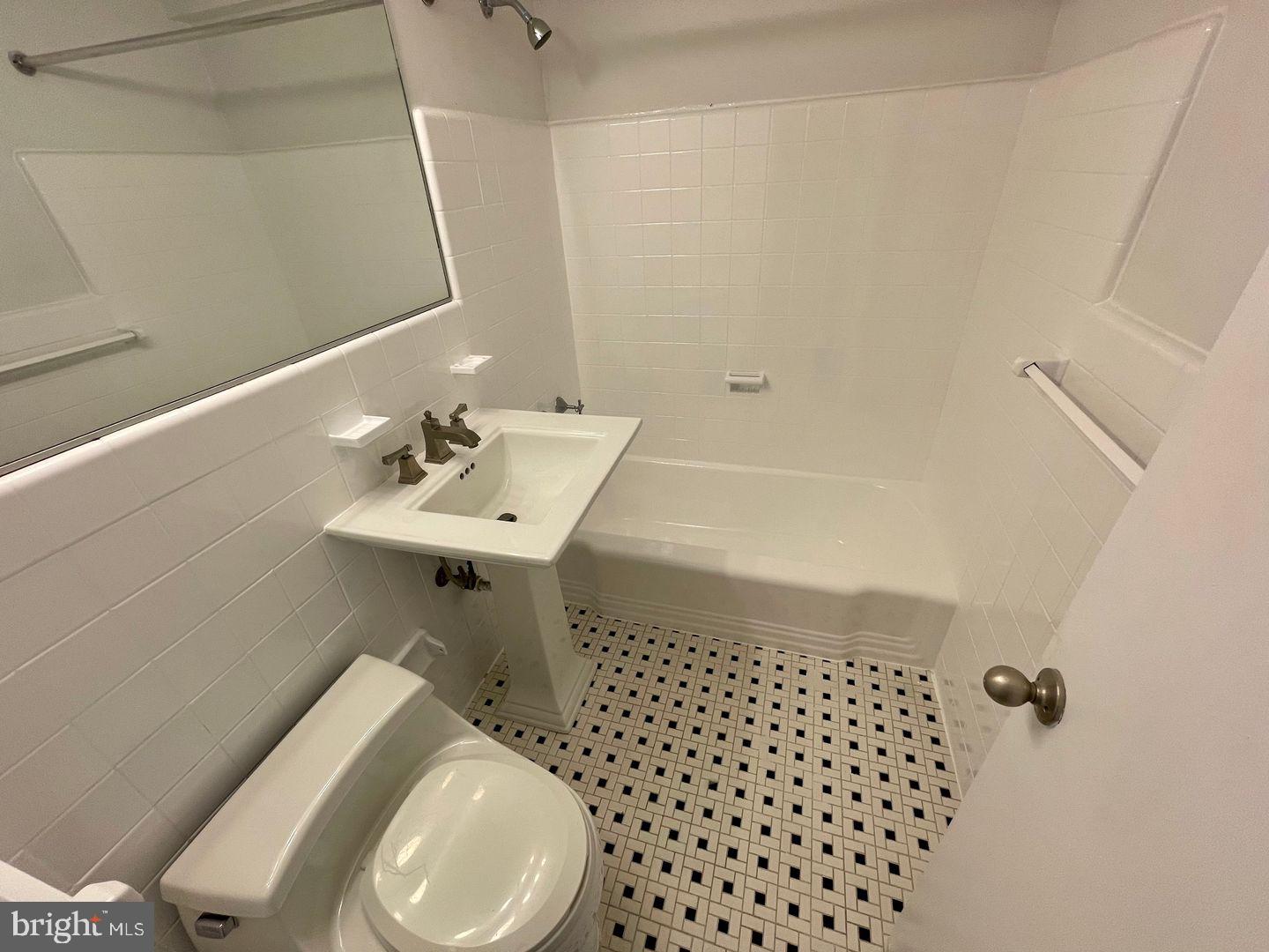 2101-17 Chestnut Street, Unit 1419 Philadelphia, PA 19103 - Photo 9 of 9 a bathroom with a sink toilet and mirror