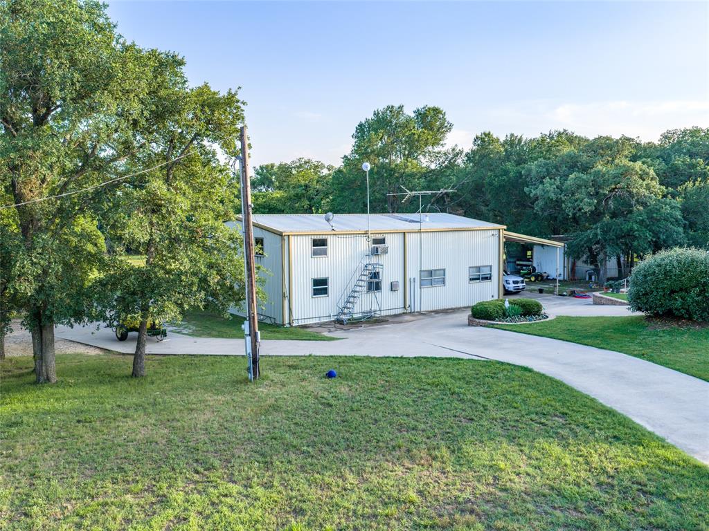 449 Private Road 4670 Rhome, TX 76078 - Photo 13 of 39 a view of house with outdoor space and tree in the background