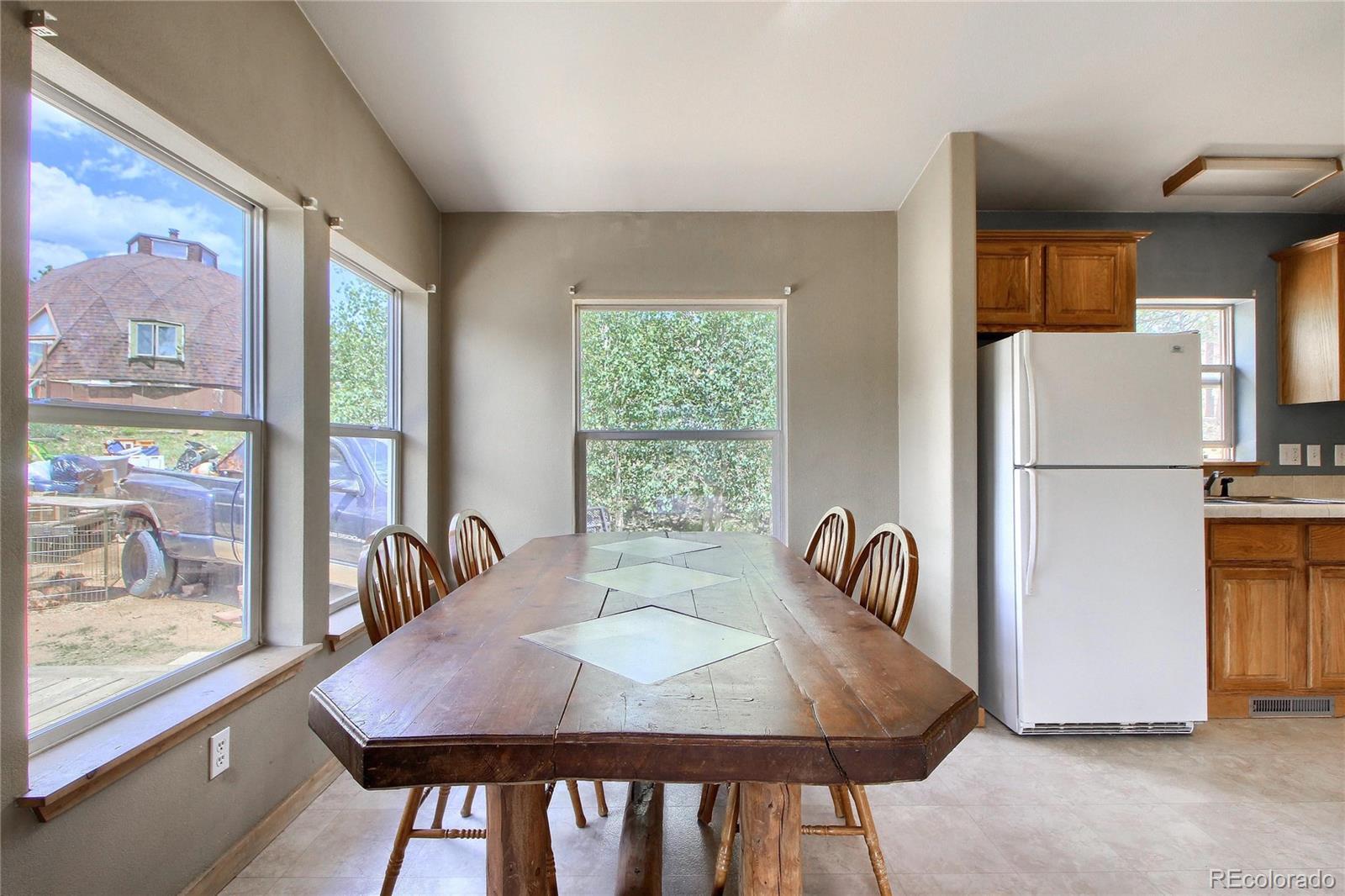 399 Buffum Street Bailey, CO 80421 - Photo 12 of 30 a dining room with furniture and a window