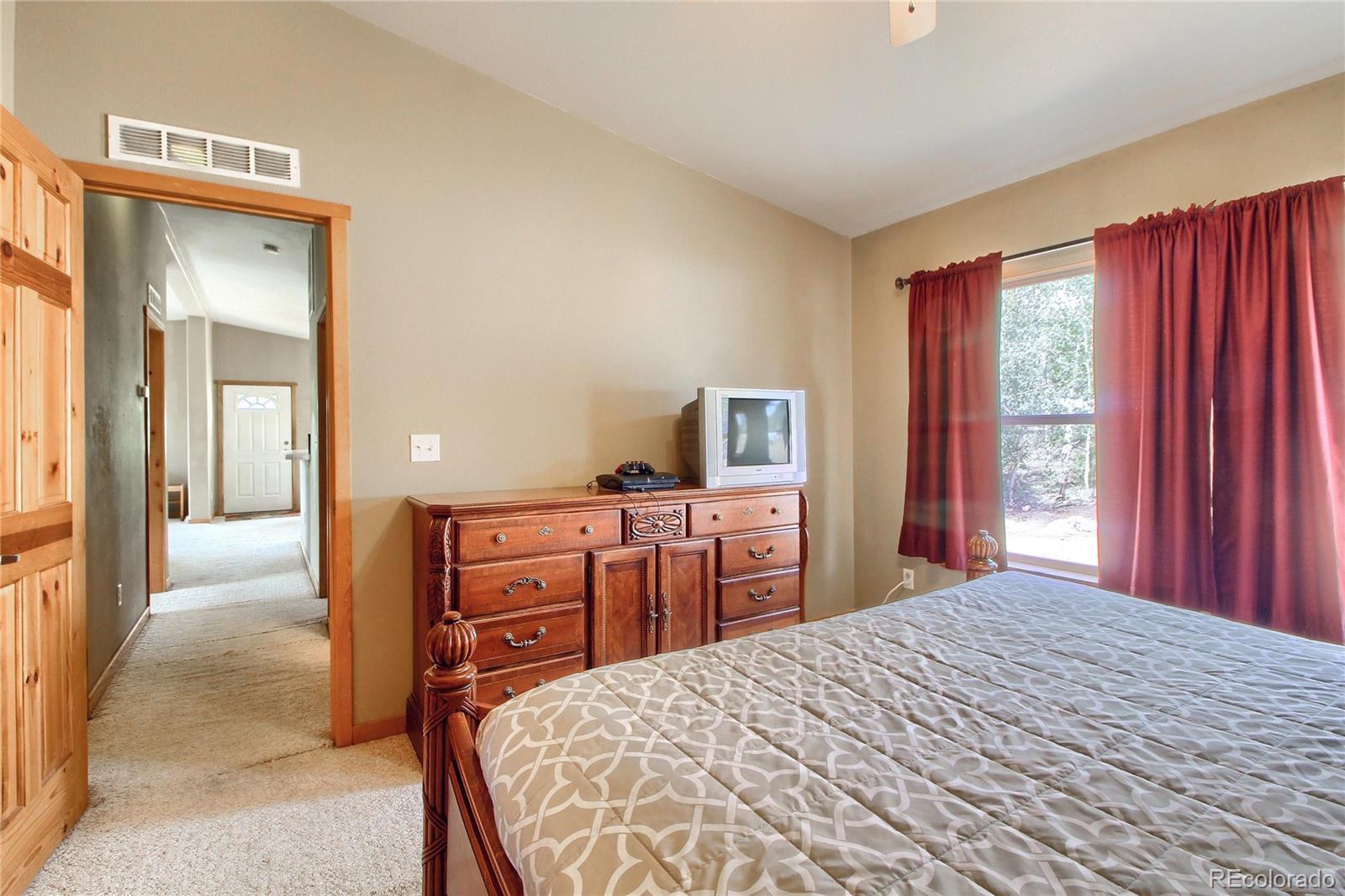 399 Buffum Street Bailey, CO 80421 - Photo 15 of 30 a bedroom with a bed and a dresser