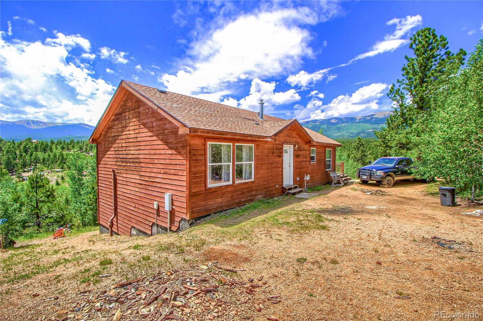 399 Buffum Street Bailey, CO 80421 - Photo 2 of 30 a view of a house with a yard