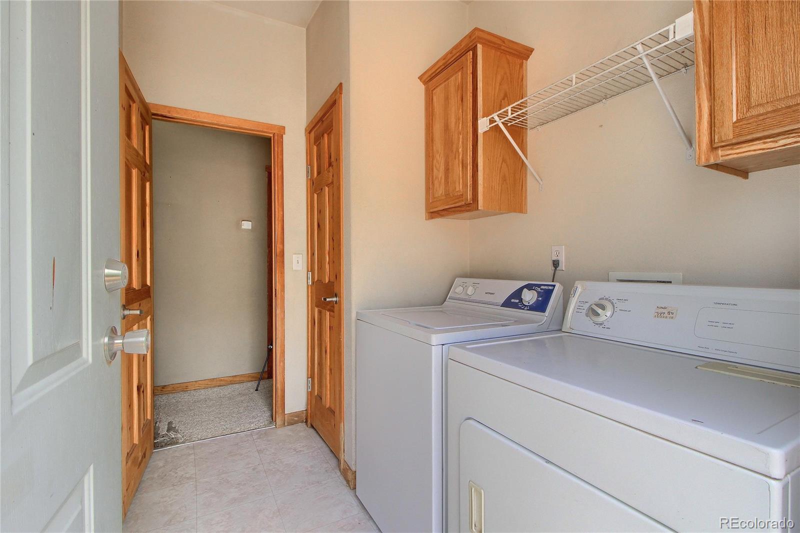 399 Buffum Street Bailey, CO 80421 - Photo 23 of 30 a view of storage and utility room with washer and dryer