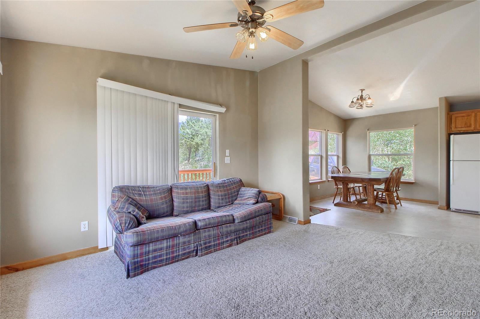 399 Buffum Street Bailey, CO 80421 - Photo 5 of 30 a living room with furniture and a large window