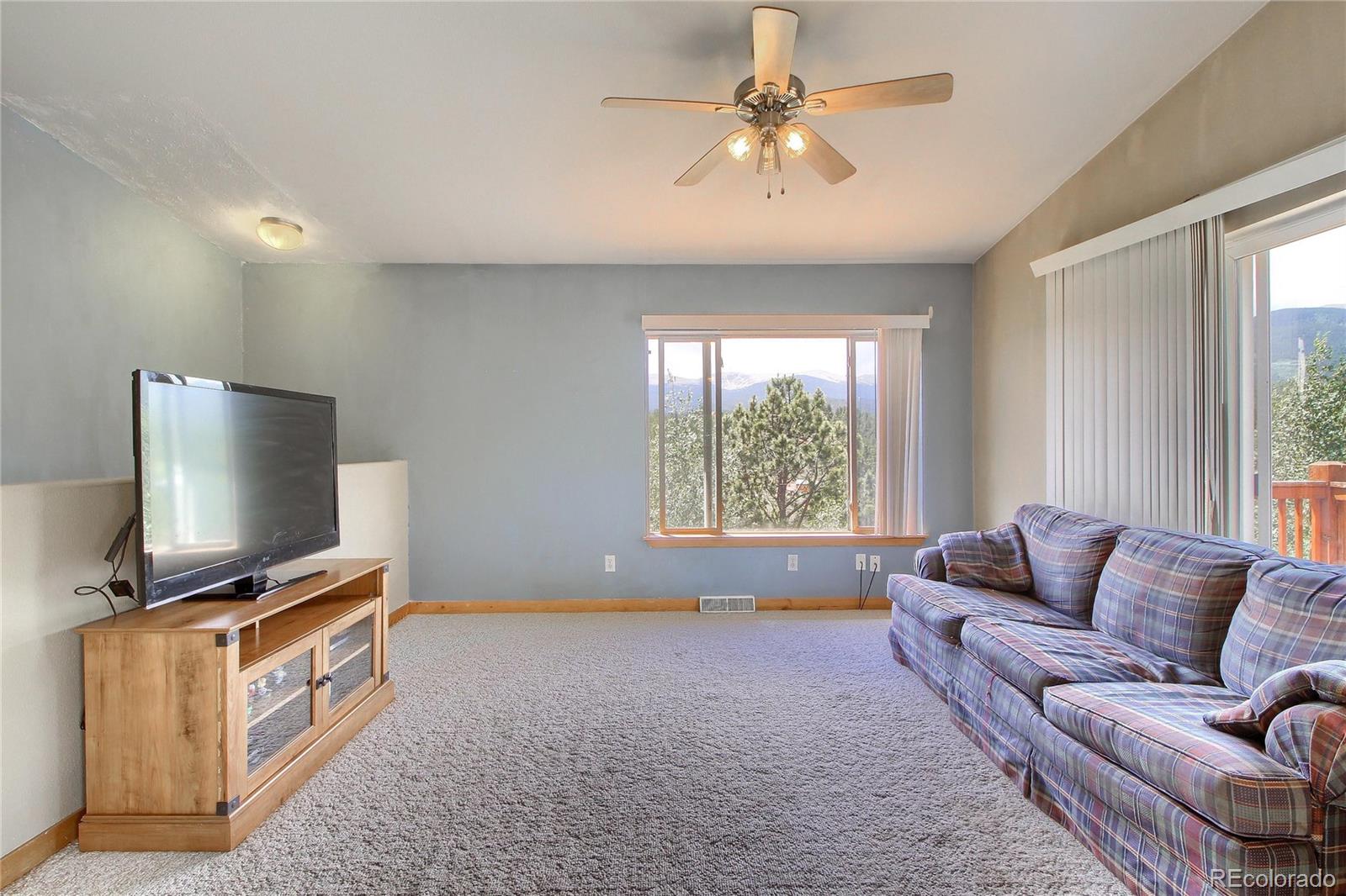 399 Buffum Street Bailey, CO 80421 - Photo 7 of 30 a living room with furniture and a flat screen tv