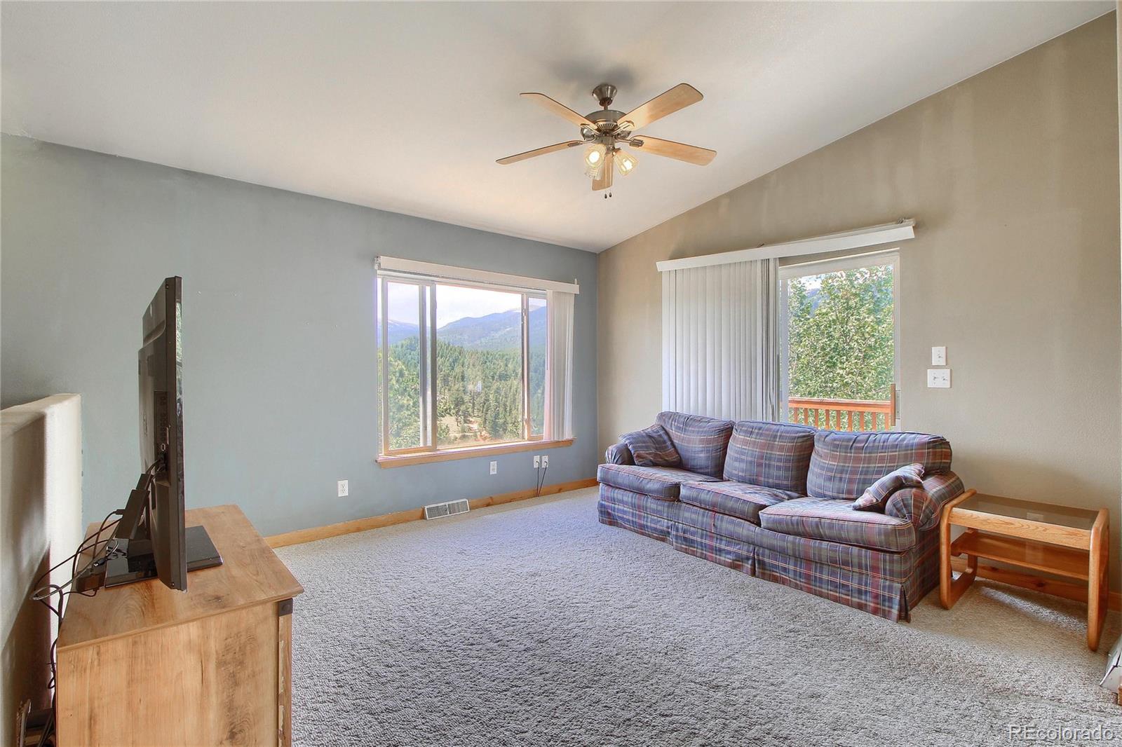399 Buffum Street Bailey, CO 80421 - Photo 8 of 30 a living room with furniture and a flat screen tv