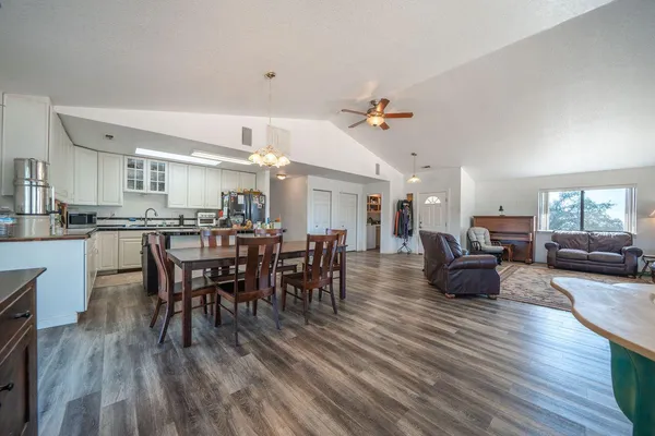 a kitchen with granite countertop white cabinets and white appliances