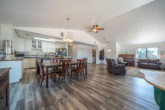 a kitchen with granite countertop white cabinets and white appliances