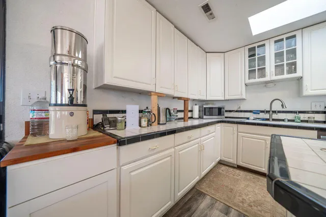 a view of a room with wooden floor and fireplace
