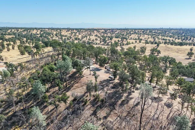 a view of a house with a yard and mountain view