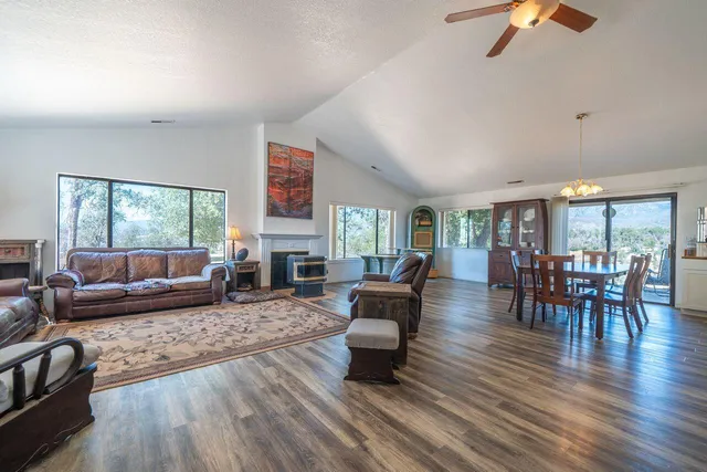 a kitchen with stainless steel appliances kitchen island granite countertop a table chairs and a refrigerator