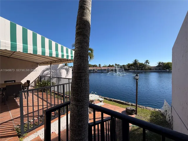 a view of two chairs and table on the deck