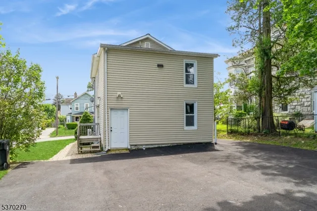 a view of a house with a yard and garage