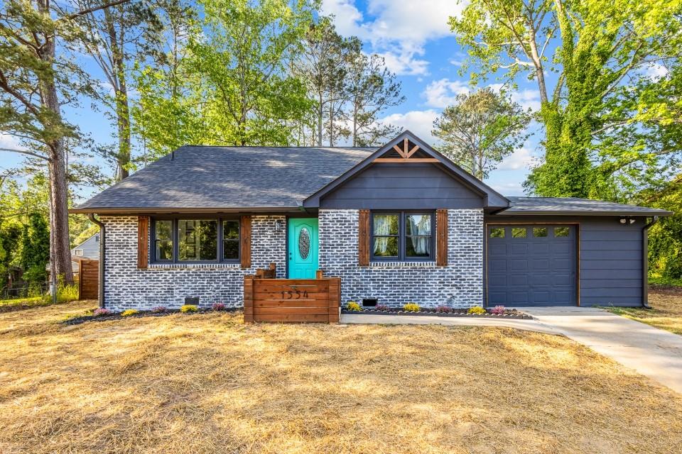 1554 Cardinal Road Hampton, GA 30228 - Photo 1 of 1 a front view of a house with a yard and a large tree