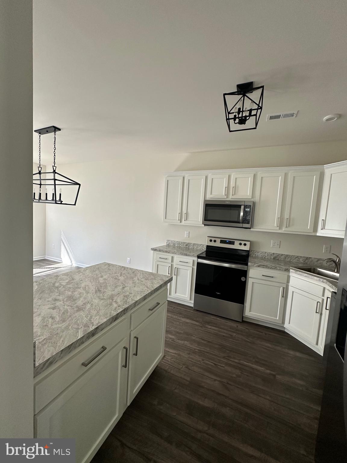 78 Tansboro Road Berlin, NJ 08009 - Photo 5 of 22 a kitchen with cabinets wooden floor and stainless steel appliances