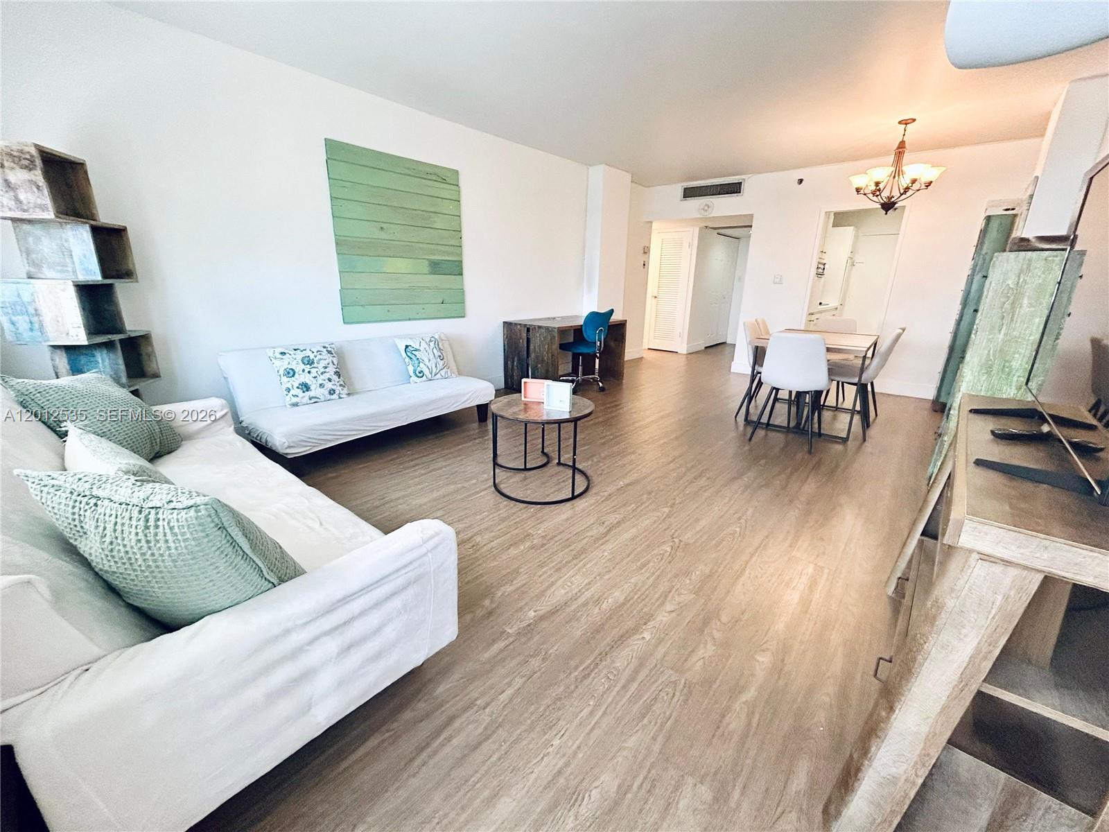100 Lincoln Road, Unit 922 Miami Beach, FL 33139 - Photo 3 of 9 a living room with furniture and wooden floor